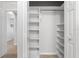 Large walk-in closet with shelving and hanging rods at 7803 Grand Estuary Trl # 102, Bradenton, FL 34212