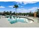 Community pool with ample lounge chairs at 7803 Grand Estuary Trl # 102, Bradenton, FL 34212