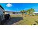 Backyard with a shed and partial view of the house at 817 Linnaen Nw Ter, Port Charlotte, FL 33948