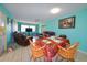 Casual dining area with wood chairs and floral tablecloth at 817 Linnaen Nw Ter, Port Charlotte, FL 33948