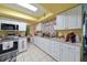 Kitchen with white cabinets, stainless steel appliances, and yellow ceiling at 817 Linnaen Nw Ter, Port Charlotte, FL 33948