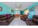 Open living room featuring brown leather furniture and ceiling fan at 817 Linnaen Nw Ter, Port Charlotte, FL 33948