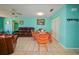 Living room with leather sofas, a dining area, and light teal walls at 817 Linnaen Nw Ter, Port Charlotte, FL 33948