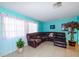 Spacious living room features a large brown sectional sofa and tile floors at 817 Linnaen Nw Ter, Port Charlotte, FL 33948