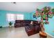 Comfortable living room with sectional sofa and decorative tree at 817 Linnaen Nw Ter, Port Charlotte, FL 33948