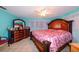 Main bedroom with king-size bed, dresser and ceiling fan at 817 Linnaen Nw Ter, Port Charlotte, FL 33948