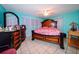 Main bedroom with a king-size bed and wood dresser at 817 Linnaen Nw Ter, Port Charlotte, FL 33948