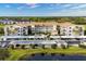 Aerial view of community featuring condo building, parking and pond at 9630 Club South Cir # 6207, Sarasota, FL 34238