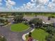 Clubhouse with circular driveway and lush landscaping at 9630 Club South Cir # 6207, Sarasota, FL 34238