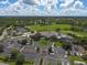 Aerial view of clubhouse with parking and surrounding golf course at 9630 Club South Cir # 6207, Sarasota, FL 34238