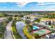 Aerial view of community with pool, tennis courts, and lush landscaping at 9630 Club South Cir # 6207, Sarasota, FL 34238