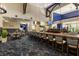 Long bar with granite countertop and numerous barstools at 9630 Club South Cir # 6207, Sarasota, FL 34238