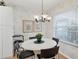 Bright dining area with a round table, four chairs, and a window with blinds at 9630 Club South Cir # 6207, Sarasota, FL 34238