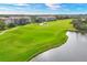 Golf course with lake and condo in background at 9630 Club South Cir # 6207, Sarasota, FL 34238