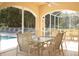 Relaxing screened porch with table and chairs overlooking the pool at 9630 Club South Cir # 6207, Sarasota, FL 34238