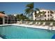 Community pool with plenty of lounge chairs for sunbathing at 9630 Club South Cir # 6207, Sarasota, FL 34238