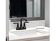 Modern bathroom vanity with black matte faucet and white countertop at 11771 Richmond Trl, Parrish, FL 34219