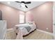 Charming bedroom with pink walls, and a ceiling fan at 11771 Richmond Trl, Parrish, FL 34219