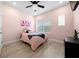 Cozy bedroom with pink walls and a queen bed at 11771 Richmond Trl, Parrish, FL 34219