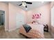 Light pink bedroom with a queen bed, double doors, and ceiling fan at 11771 Richmond Trl, Parrish, FL 34219