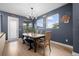 Bright dining room features a wooden table, bench, and chairs, with large windows and a chandelier at 11771 Richmond Trl, Parrish, FL 34219