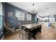 Open concept dining area with a view into the kitchen, featuring a rustic dining set and chandelier at 11771 Richmond Trl, Parrish, FL 34219