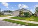 One-story house with gray siding, stone accents, and a two-car garage at 11771 Richmond Trl, Parrish, FL 34219