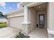 Inviting house exterior with a two-car garage and stone accents at 11771 Richmond Trl, Parrish, FL 34219