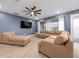 Spacious living room boasts a large sectional sofa, chaise lounge, and ceiling fan at 11771 Richmond Trl, Parrish, FL 34219