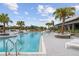 Resort-style pool with lounge chairs and palm trees at 11771 Richmond Trl, Parrish, FL 34219