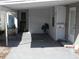 Covered carport with exterior door and trash can at 12 Desoto E St, Bradenton, FL 34208