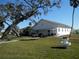 White community building with benches and landscaping at 12 Desoto E St, Bradenton, FL 34208