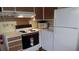 White refrigerator and electric stove at 12 Desoto E St, Bradenton, FL 34208