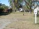 Dirt parking area with signage and yard at 12 Desoto E St, Bradenton, FL 34208