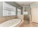 Elegant bathroom with soaking tub, walk-in shower, and tiled floor at 12219 23Rd E St, Parrish, FL 34219