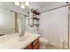 Bathroom with shower, toilet, and rustic shelving at 12219 23Rd E St, Parrish, FL 34219