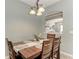 Bright dining room with wooden table and view into the living area at 12219 23Rd E St, Parrish, FL 34219