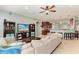 Open-concept living room flowing into the kitchen featuring modern finishes and comfortable furnishings at 12219 23Rd E St, Parrish, FL 34219