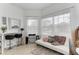 Bright sitting area with white couch and a vanity at 12219 23Rd E St, Parrish, FL 34219