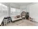 Sunlit sitting area featuring a white couch and wicker chair at 12219 23Rd E St, Parrish, FL 34219