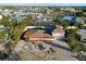 Aerial view of a light pink house with a large yard at 128 51St St # A, Holmes Beach, FL 34217