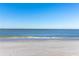 Expansive beach view with clear blue water and footprints in the sand at 128 51St St # A, Holmes Beach, FL 34217