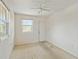 Empty bedroom with ceiling fan and exterior access at 128 51St St # A, Holmes Beach, FL 34217