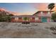 Two-story house with light pink exterior, teal garage door, and landscaping at 128 51St St # A, Holmes Beach, FL 34217