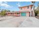 Two-story house with teal garage door and side stairs at 128 51St St # A, Holmes Beach, FL 34217