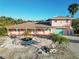 Two-story house with light pink exterior and teal garage door at 128 51St St # A, Holmes Beach, FL 34217