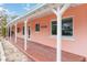 Long covered porch on a light pink house at 128 51St St # A, Holmes Beach, FL 34217