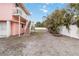 Pink two-story house with a wooden staircase and a fenced yard at 128 51St St # A, Holmes Beach, FL 34217