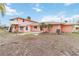 Back view of a light pink house with a patio and surrounding yard at 128 51St St # A, Holmes Beach, FL 34217