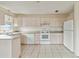 Small kitchen with light wood cabinets and white appliances at 128 51St St # A, Holmes Beach, FL 34217